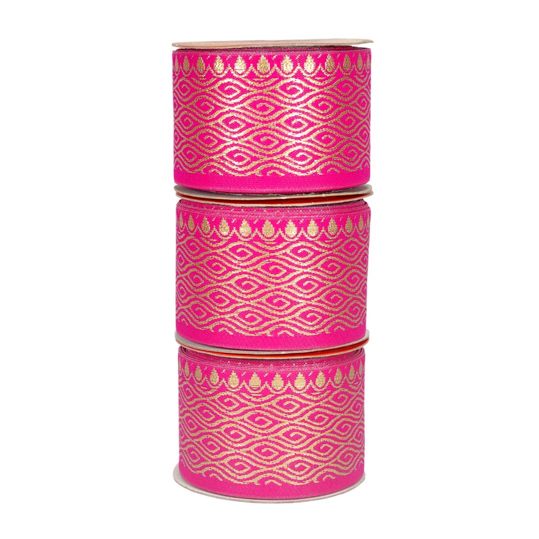 Stack of pink containers with gold geometric patterns on a white background