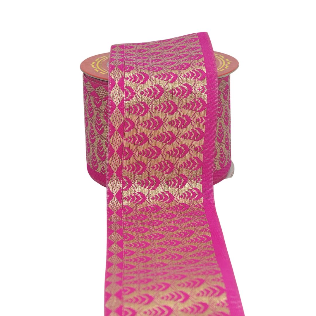 Pink and gold patterned fabric roll on a white background