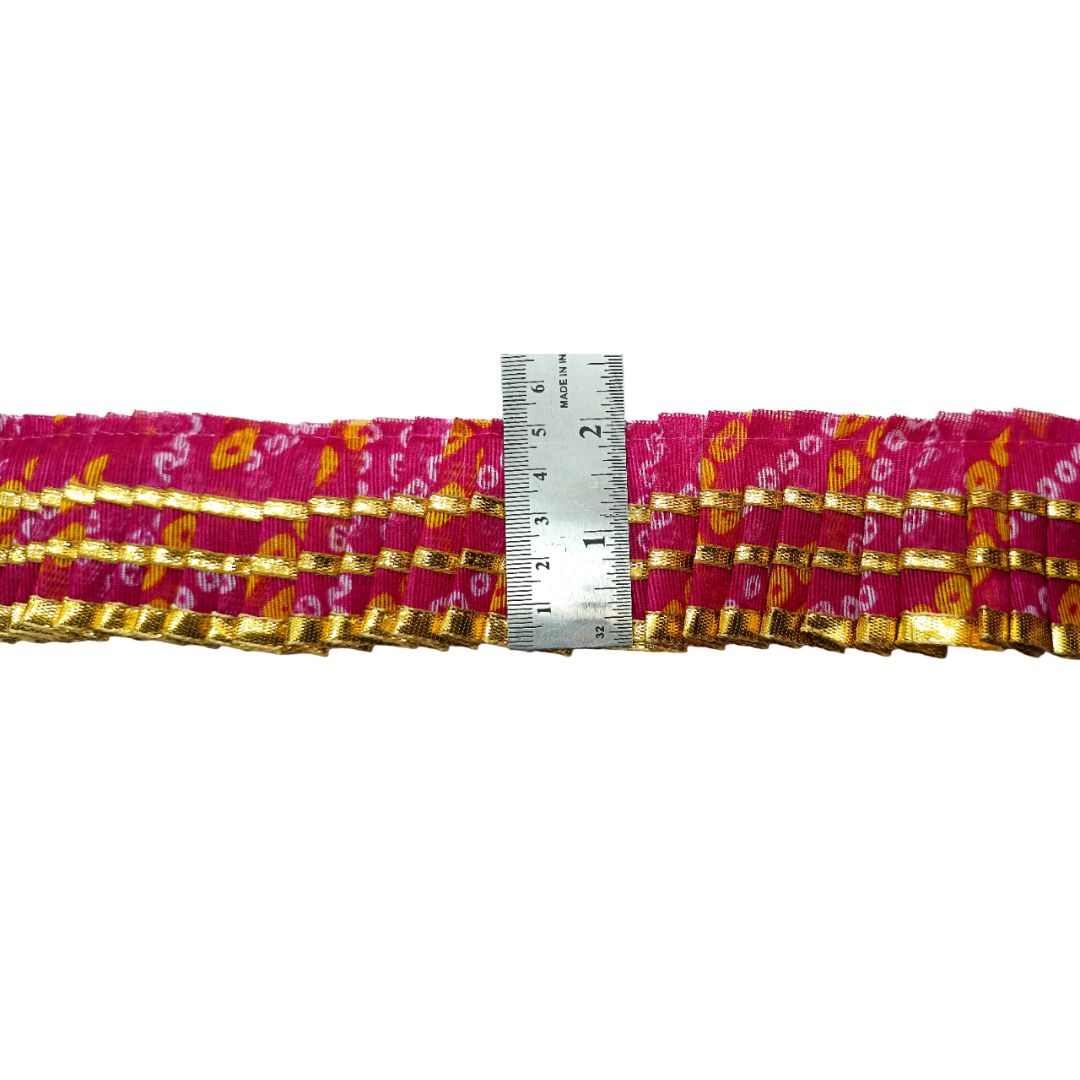 Multicolored fabric strip with a ruler for scale on a white background