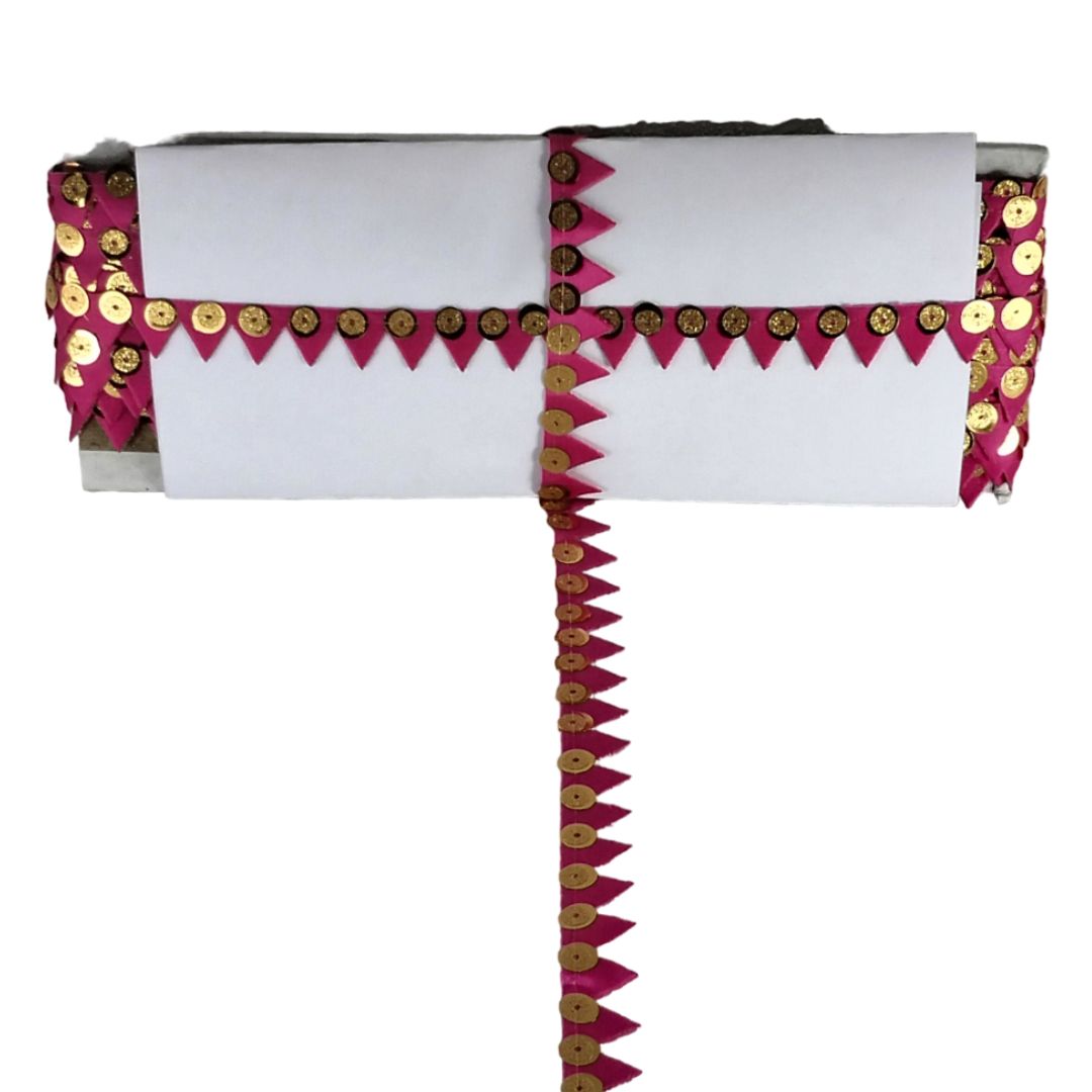 Decorative headpiece with pink and gold accents on a white background