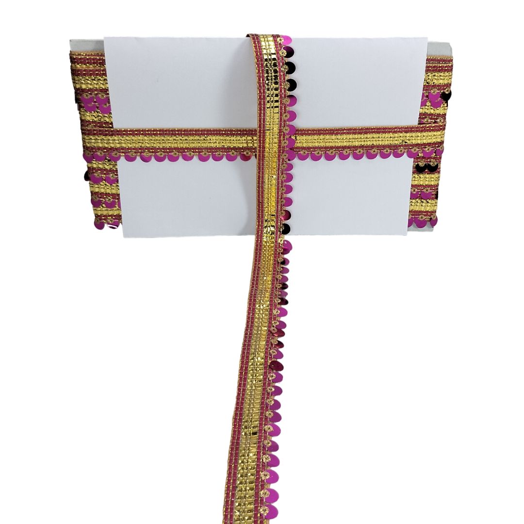 Decorative fabric border with gold, pink, and black patterns on a white background