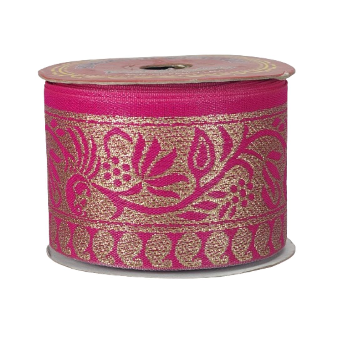 Spool of pink and gold floral ribbon on a white background