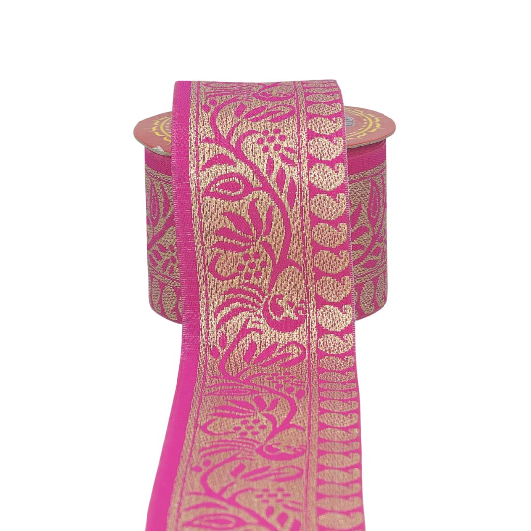 Pink ribbon with gold floral patterns on a white background