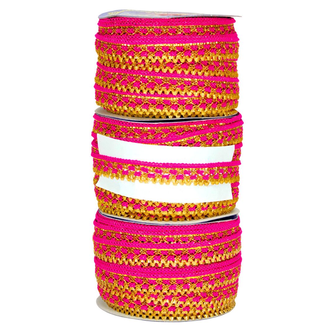 Three spools of pink and gold ribbon stacked on a white background