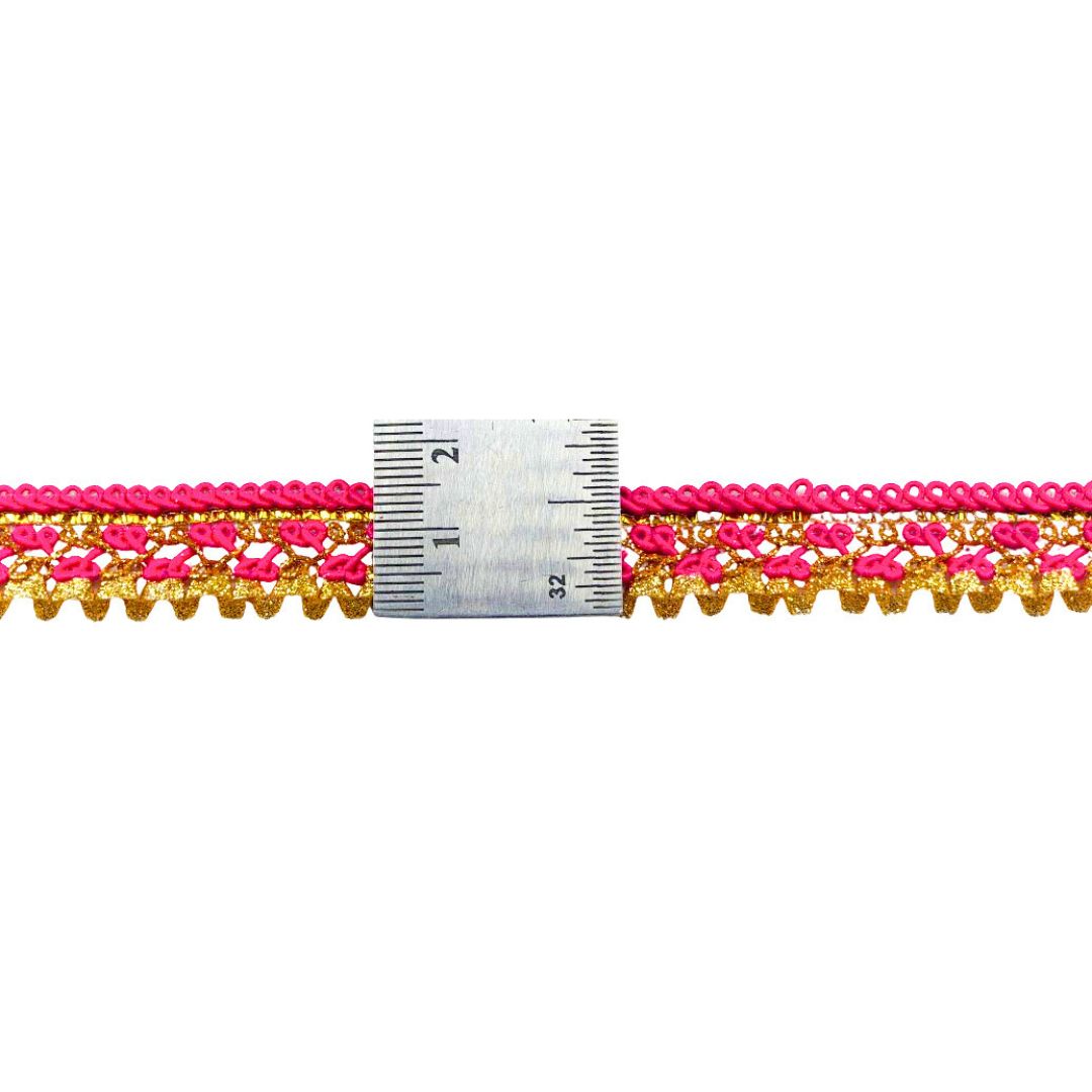 Pink and gold lace trim with a ruler for measurement on a white background