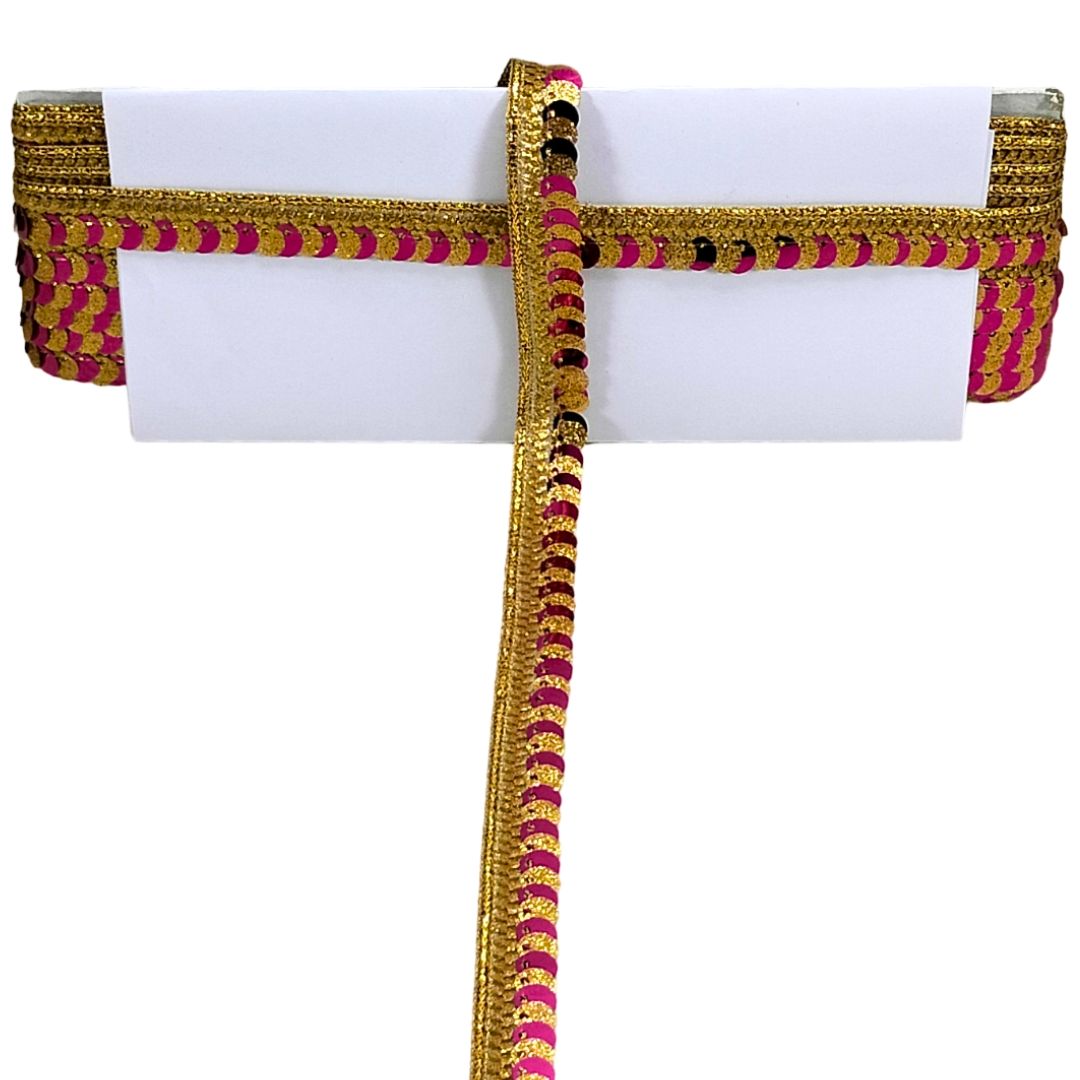 Decorative belt with gold and pink pattern on a white background