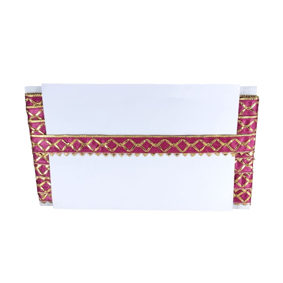 White saree with pink and gold border on a white background