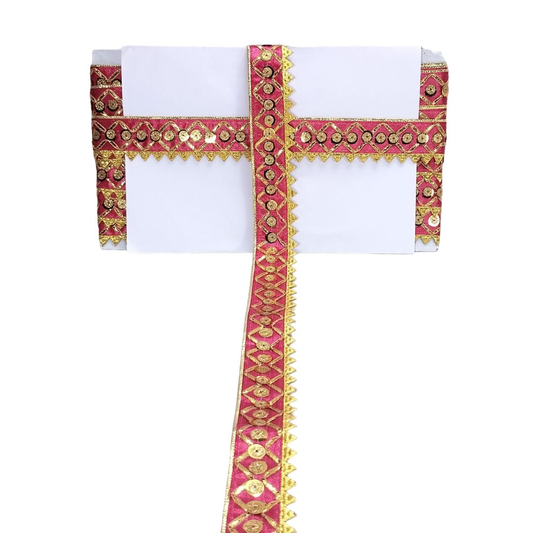 Decorative white fabric with pink and gold embroidered border on a white background