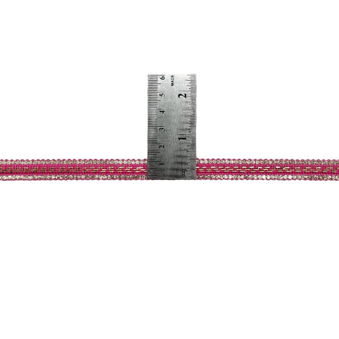 Pink beaded ribbon with a ruler for measurement on a white background