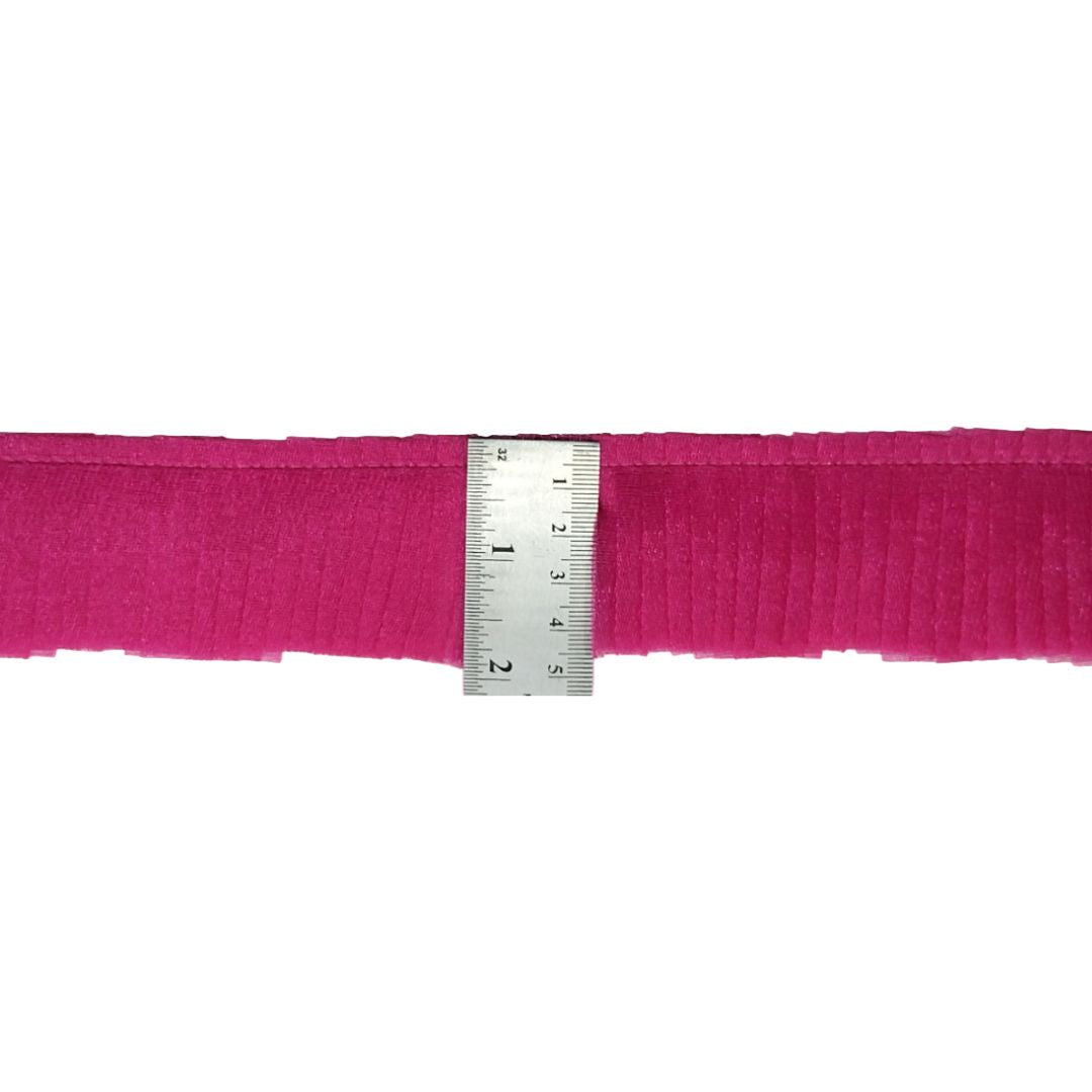Pink belt with a metal measuring ruler on a white background