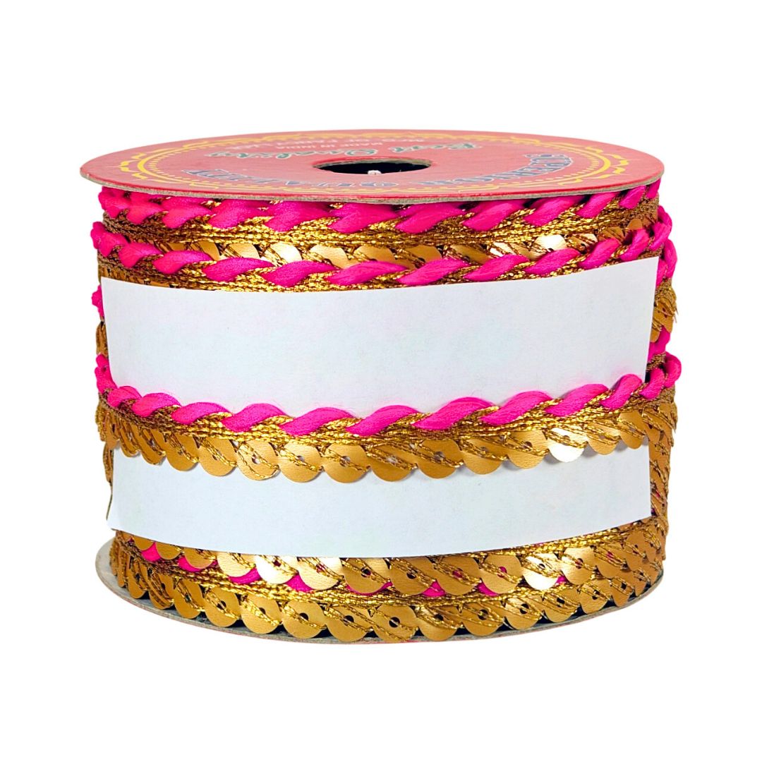 Spool of ribbon with gold and pink design on a white background