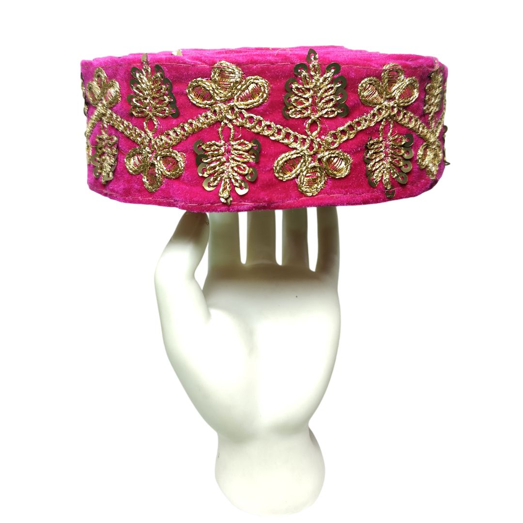 Pink headband with gold embroidery on a white background