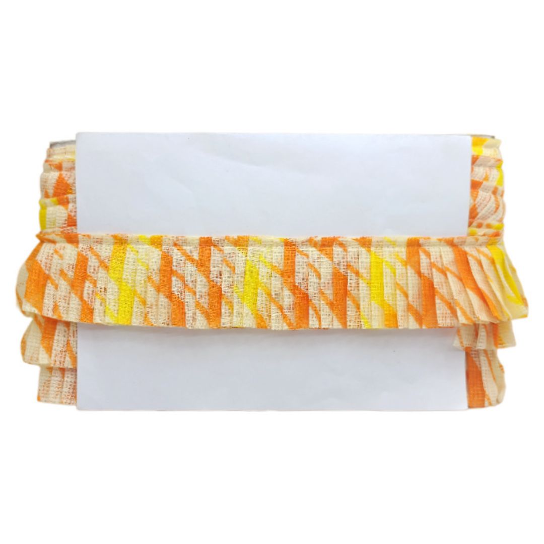 Stack of folded towels with orange and yellow pattern on a white background