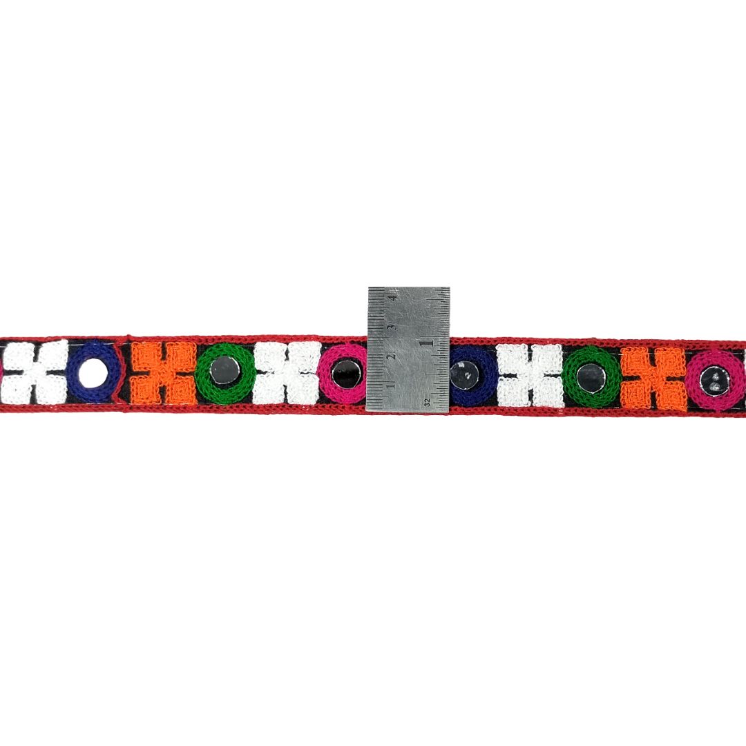 Colorful belt with geometric pattern and ruler for size reference on a white background