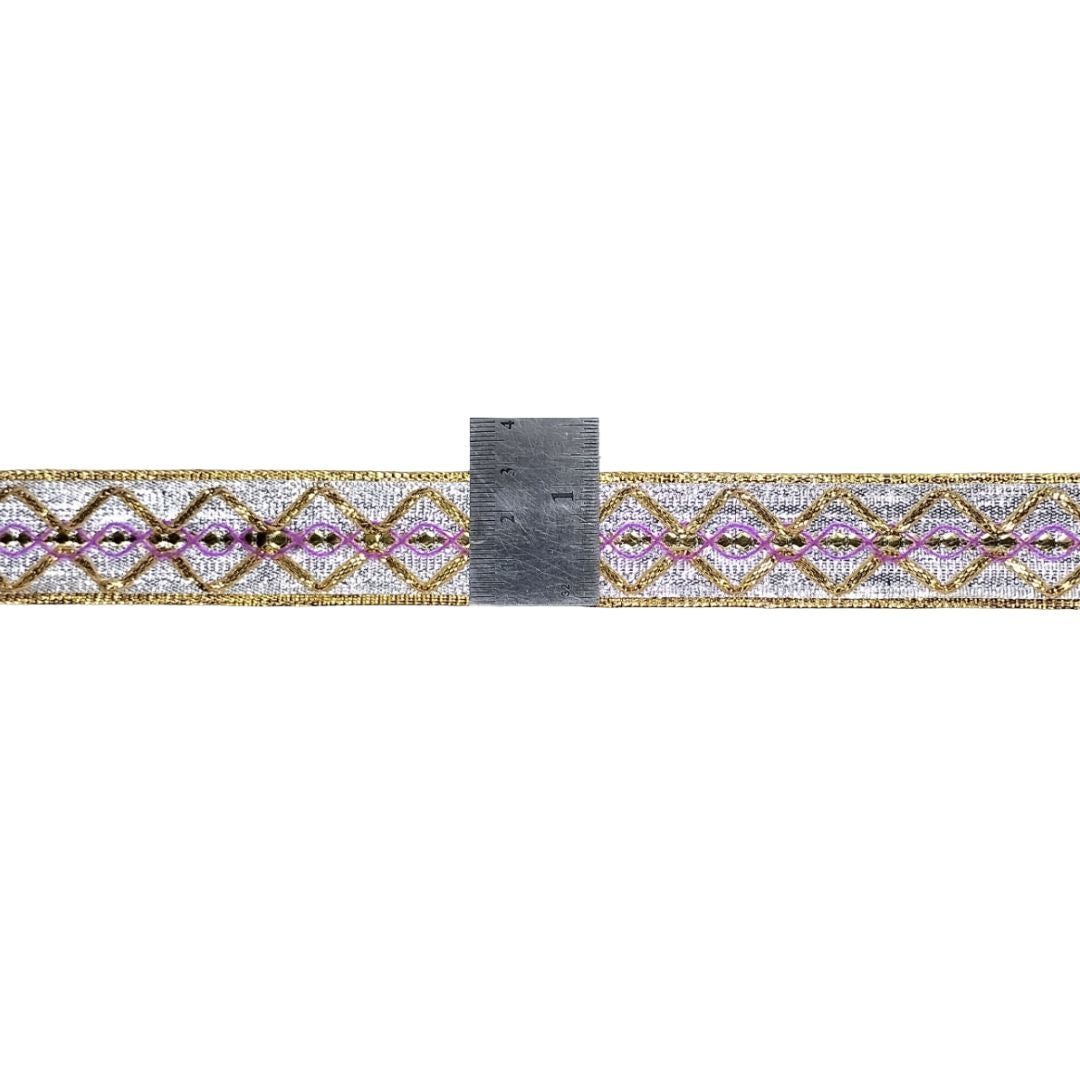 Decorative belt with geometric pattern and ruler for scale on a white background
