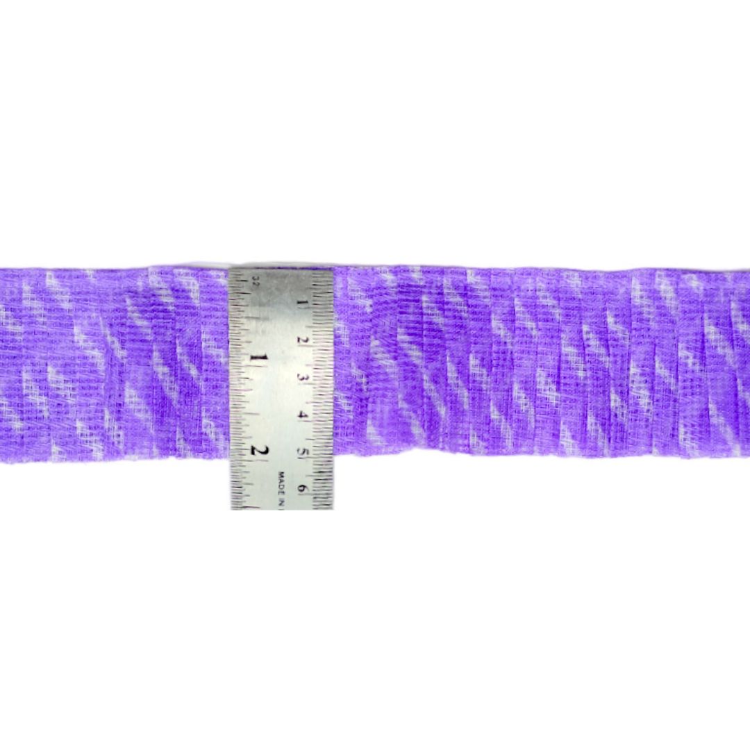 Purple fabric with a ruler for scale on a white background
