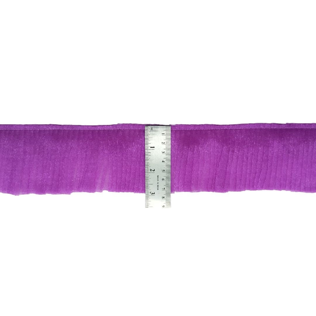 Purple ribbon with a ruler for measurement on a white background