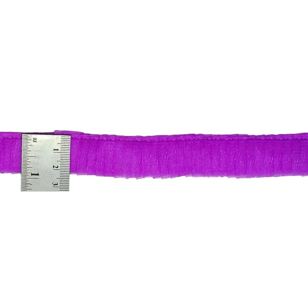 Purple ribbon with a metal ruler on a white background