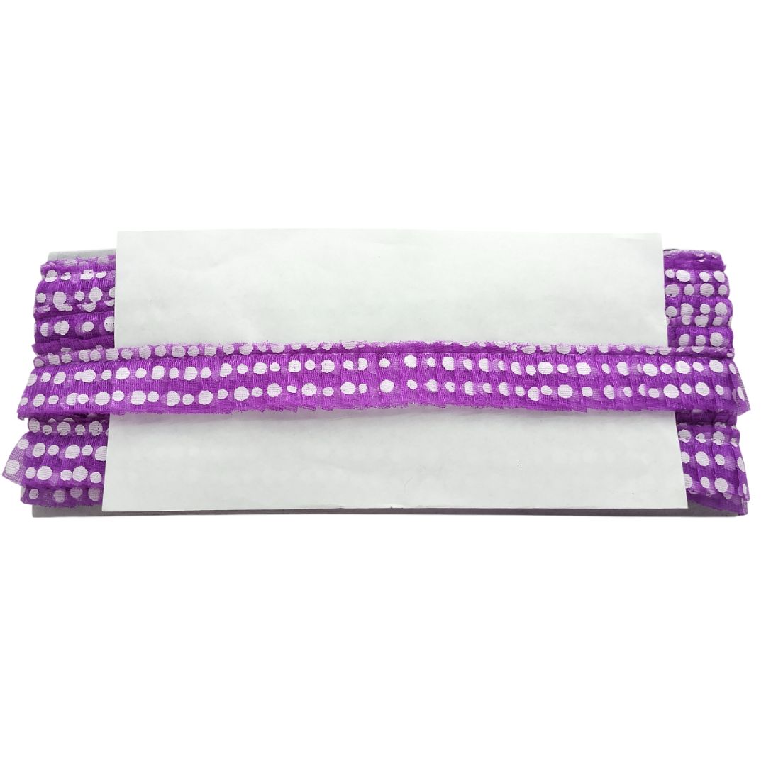 Purple polka dot headband on a white background