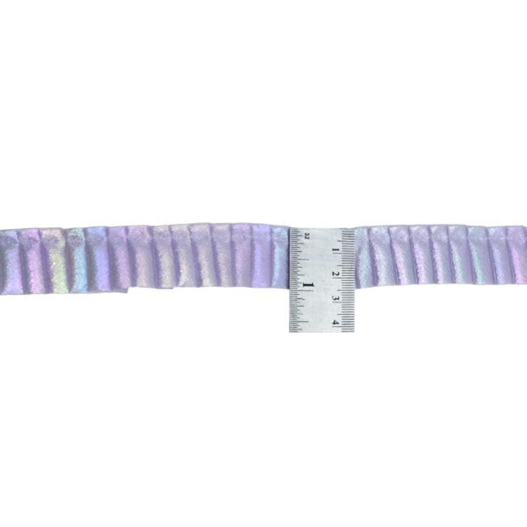 Stripes of purple fabric with a ruler for scale on a white background