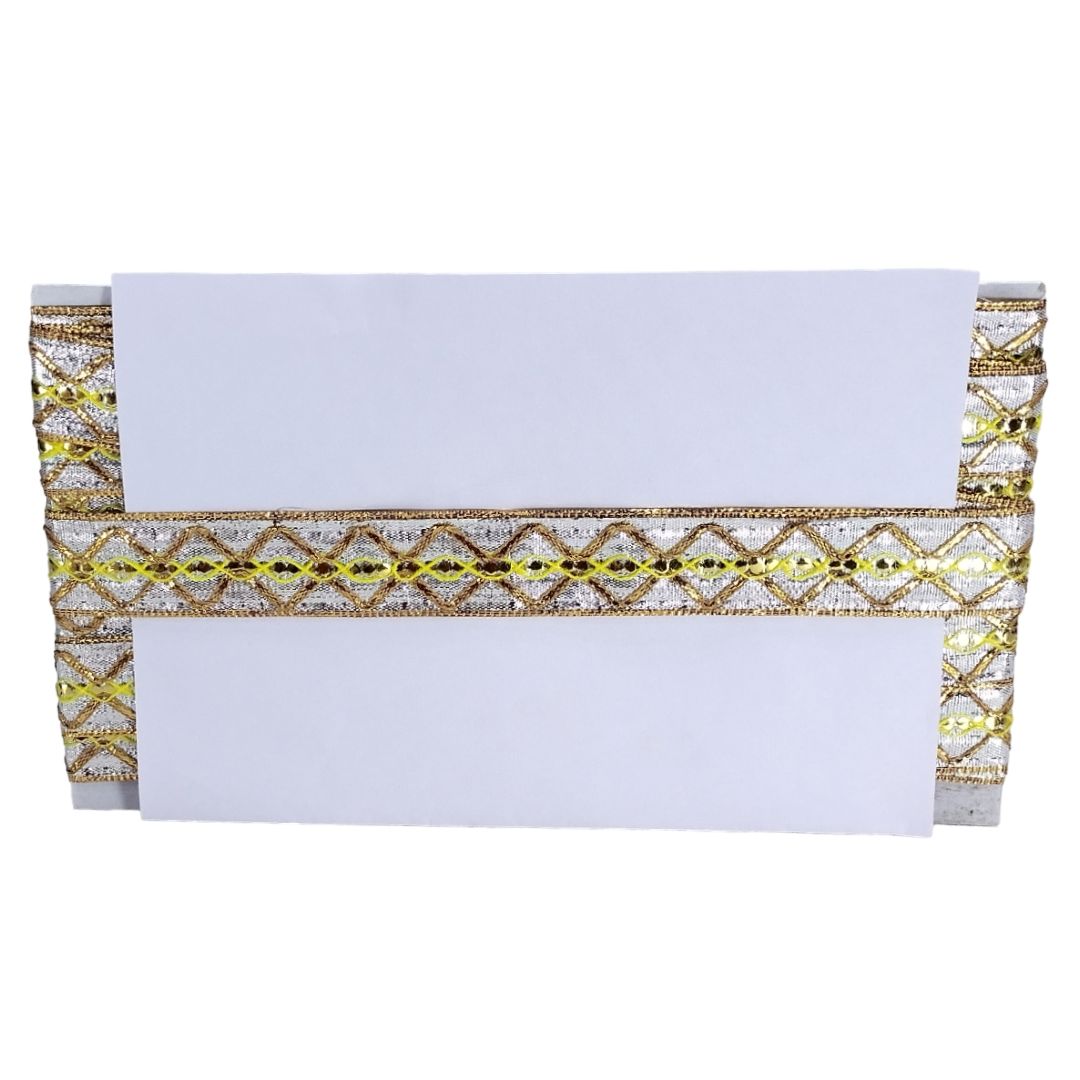 White clutch with gold and yellow pattern on a white background