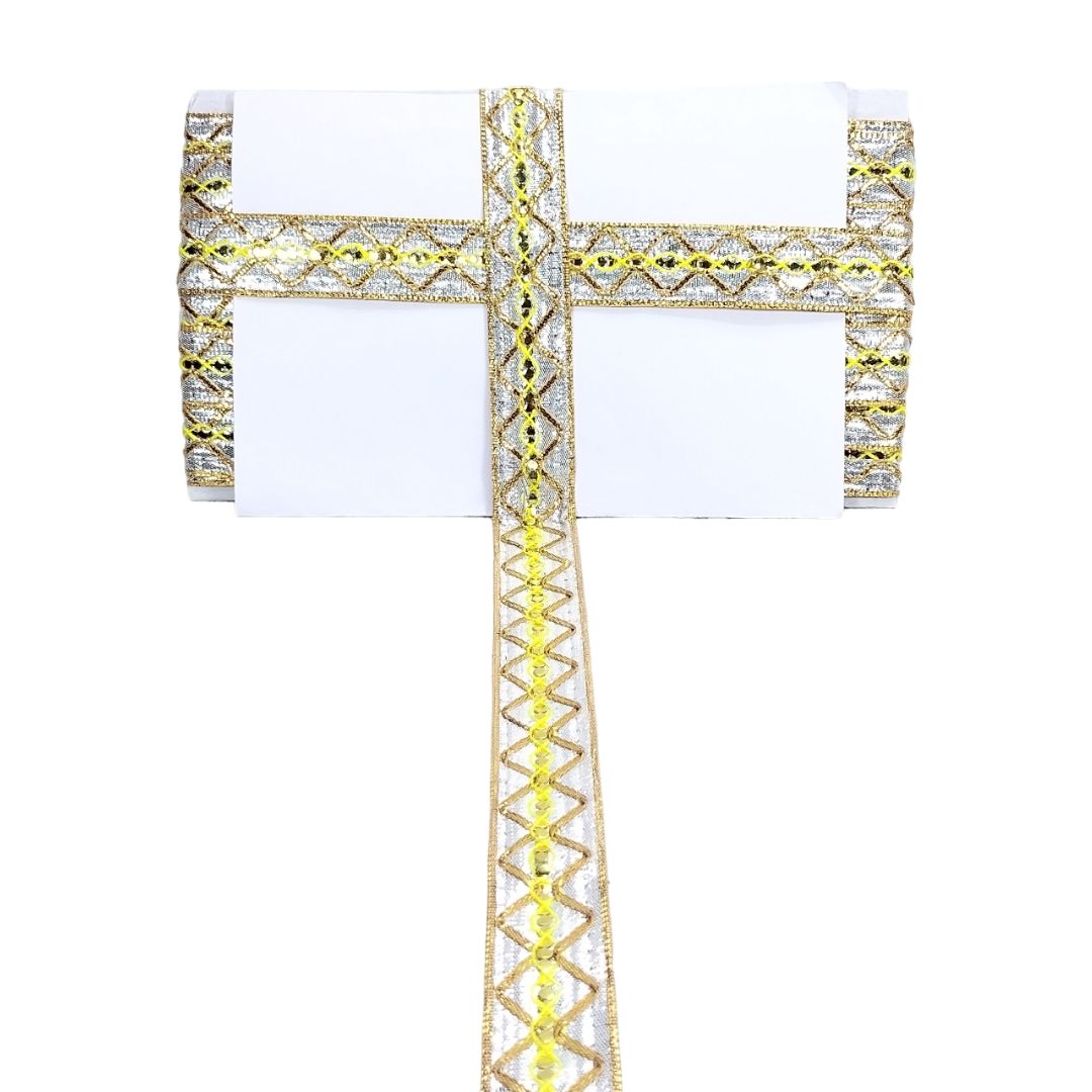 Gold cross pendant with clear gemstones on a white background