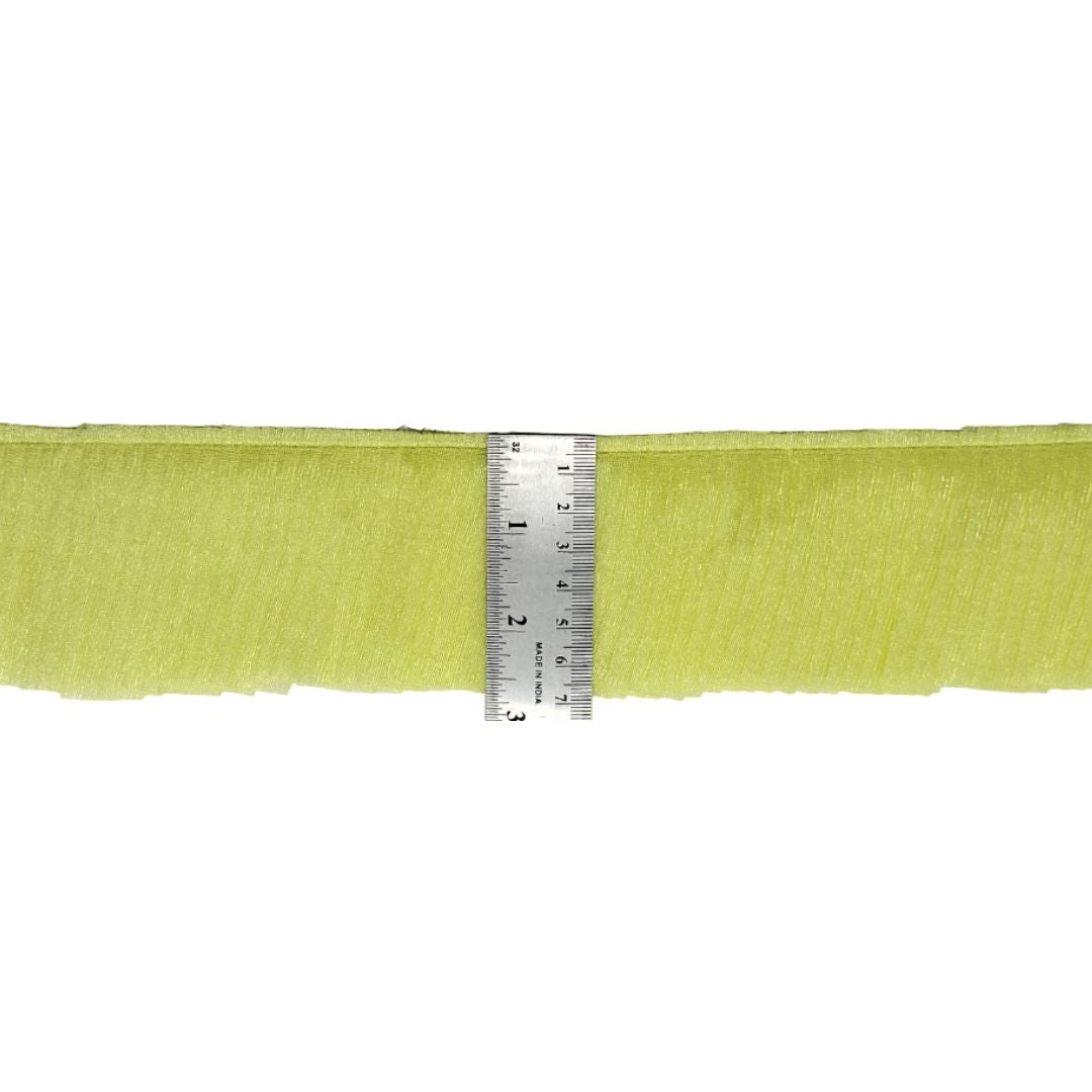Green ribbon with a ruler for scale on a white background