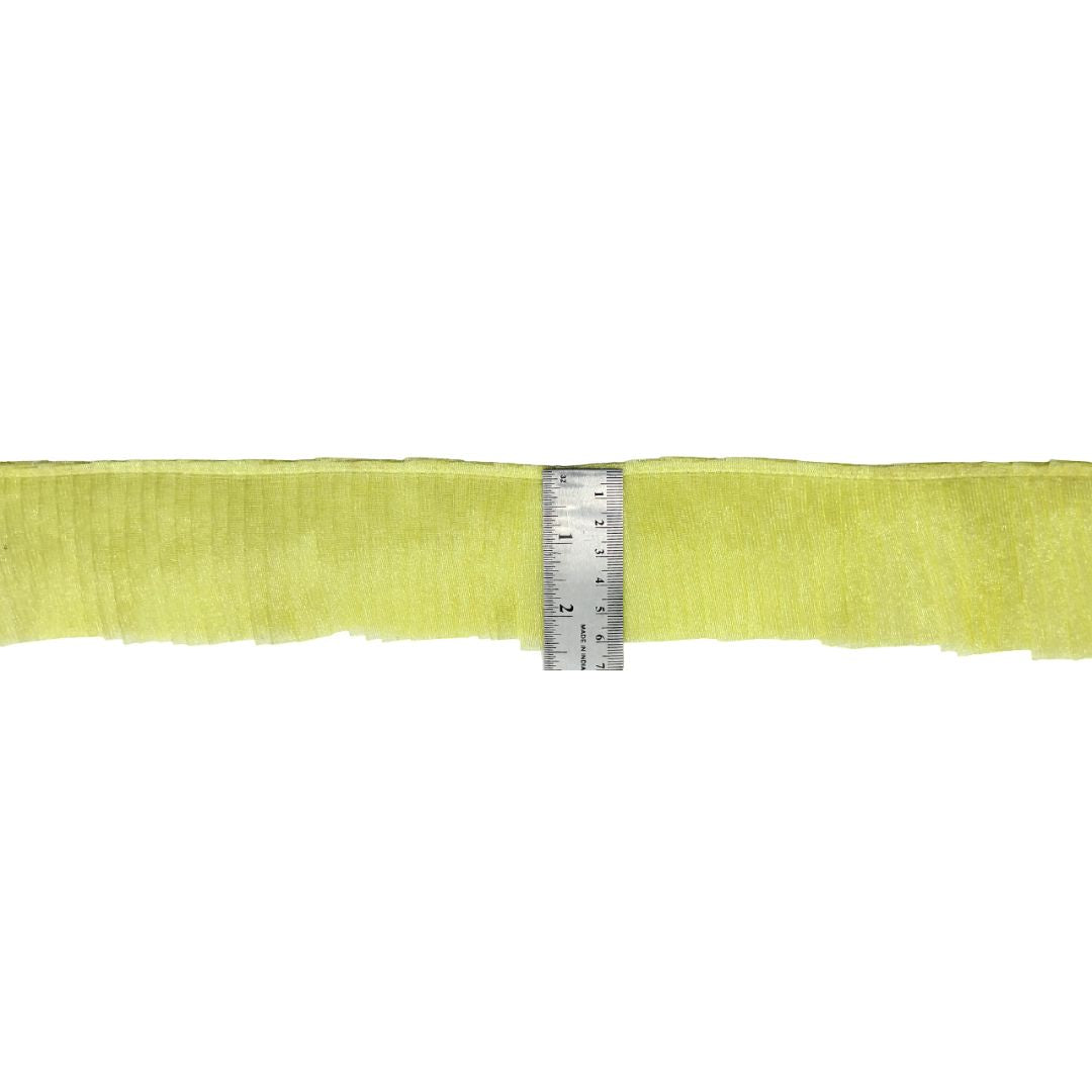 Strip of yellow fabric with a ruler for scale on a white background