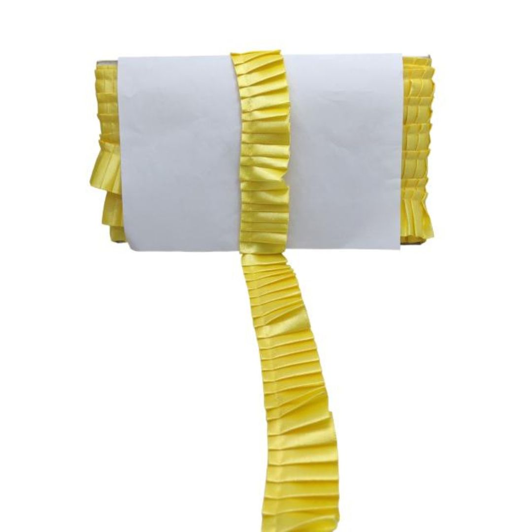 White chair cover with yellow ruffled trim on a white background