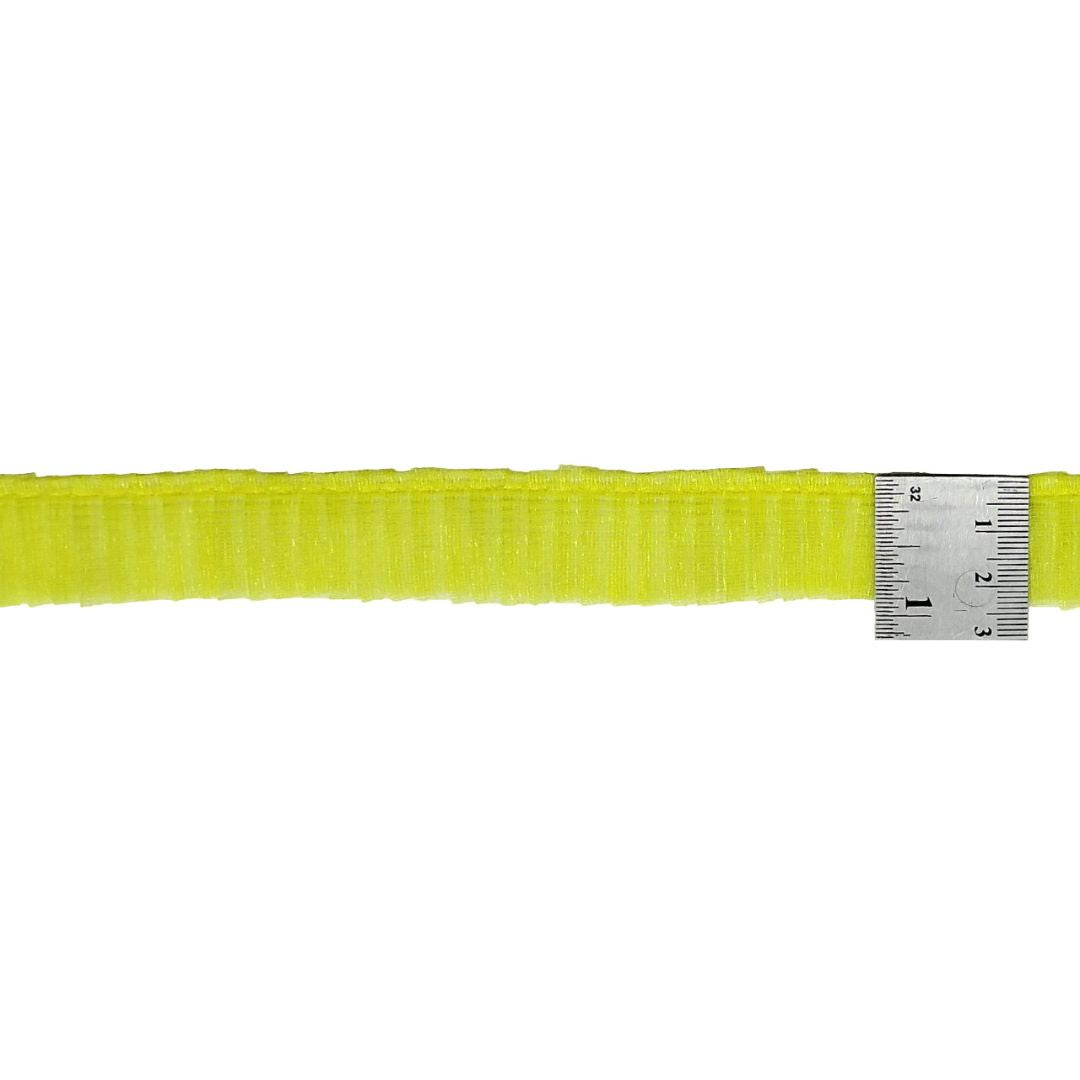 Yellow belt with a metal ruler for scale on a white background