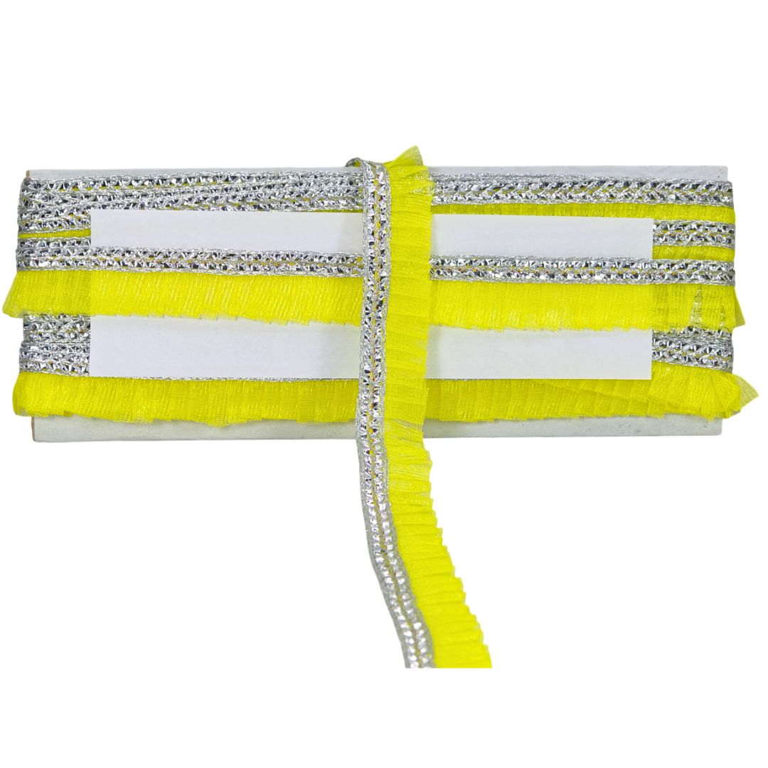 Decorative fabric strip with yellow, white, and silver colors on a white background