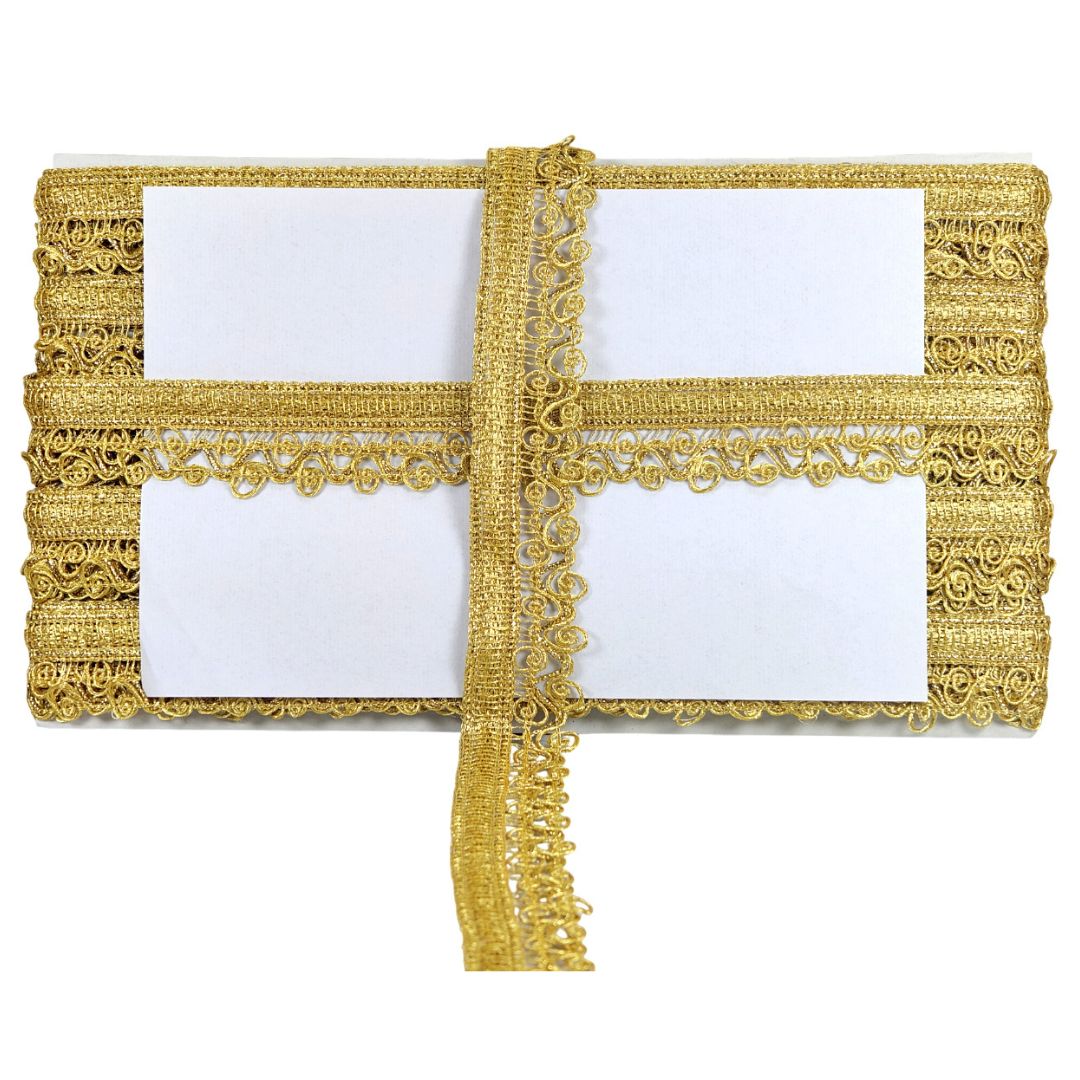 Decorative gold clutch with intricate patterns on a white background