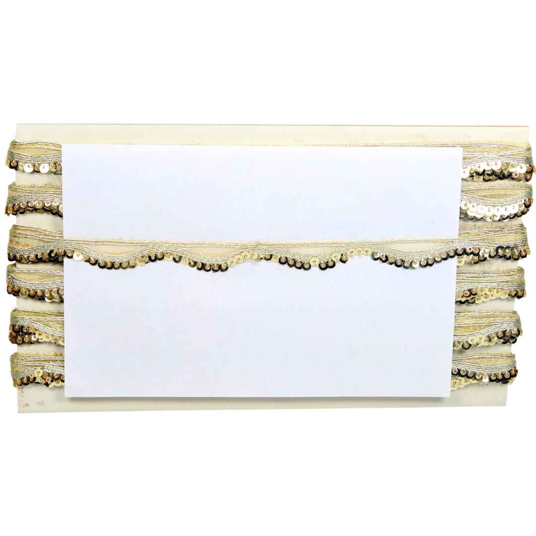 Stack of white cards with decorative gold trim on a white background