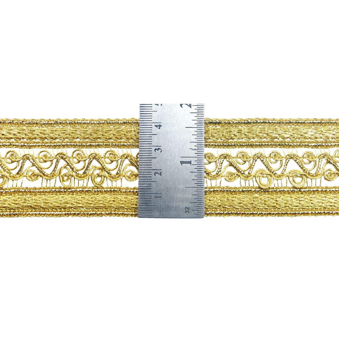 Gold lace trim with a ruler for measurement on a white background