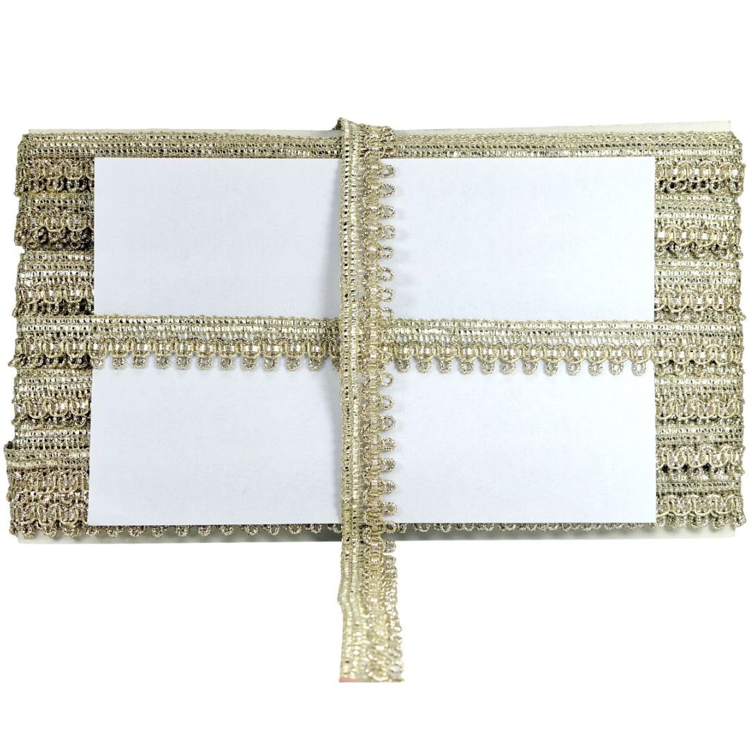Two white placemats with gold fringe on a white background