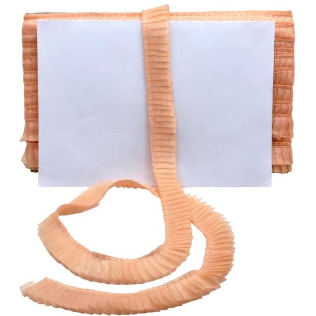 Folded fabric with a white center and peach-colored edges on a white background
