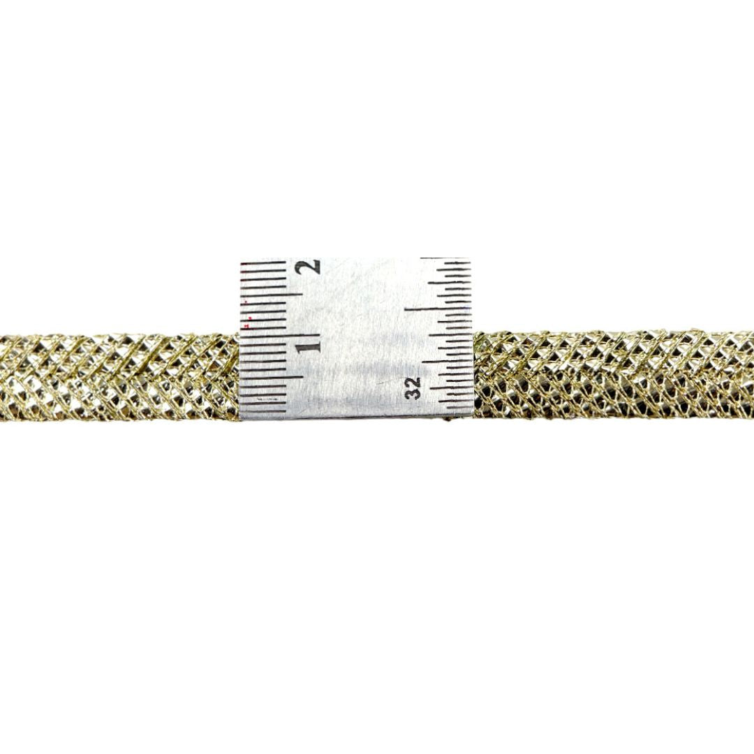 Gold mesh strip with a ruler for measurement on a white background