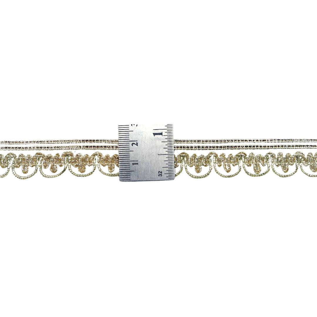 Gold chain with a ruler for scale on a white background