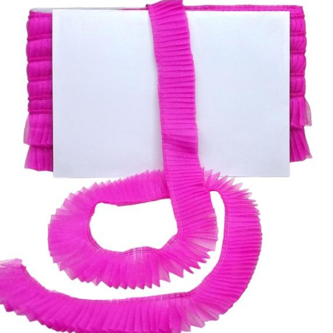 Pink springy resistance band with a white card on a white background