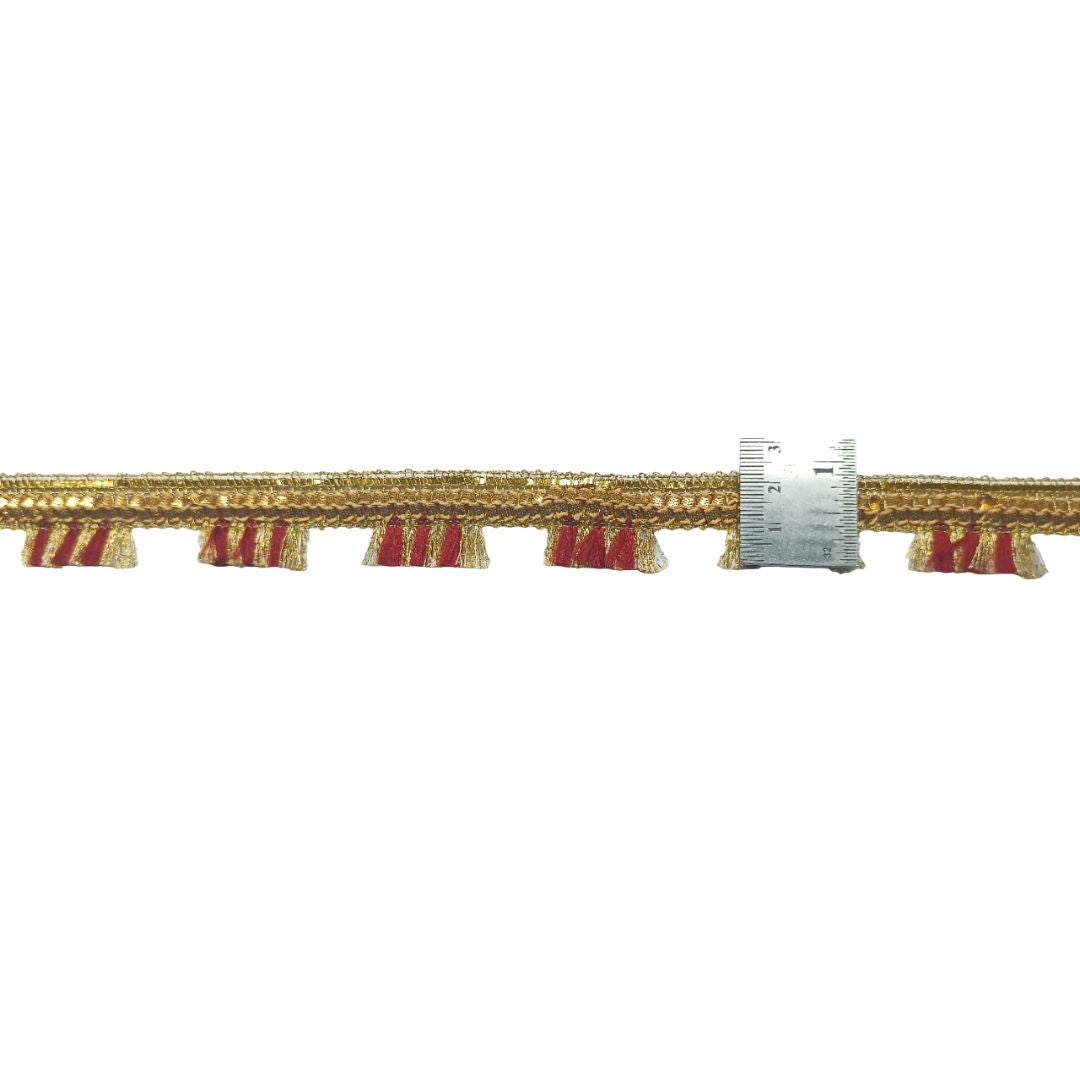 Decorative cornice with gold and red fringe on a white background