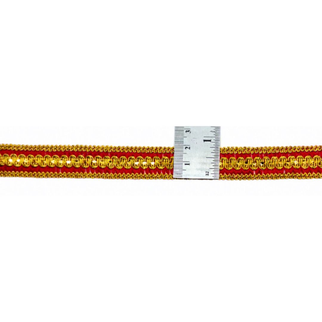 Red and gold braided cord with a ruler for scale on a white background