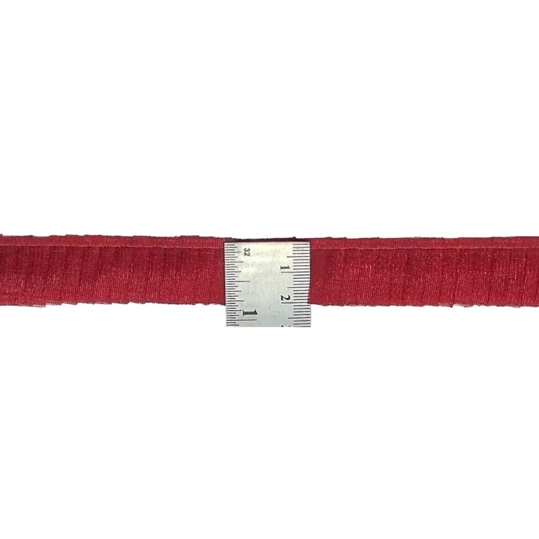 Red belt with a silver measuring ruler on a white background