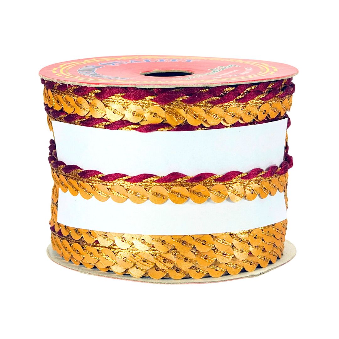 Spool of gold and red braided ribbon on a white background
