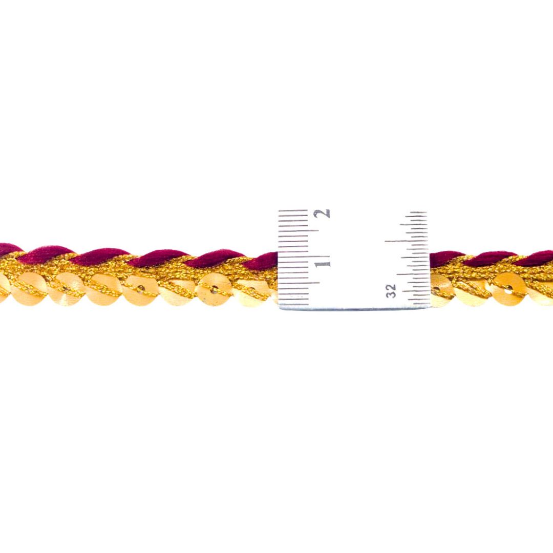 Gold and red braided cord with a ruler for scale on a white background