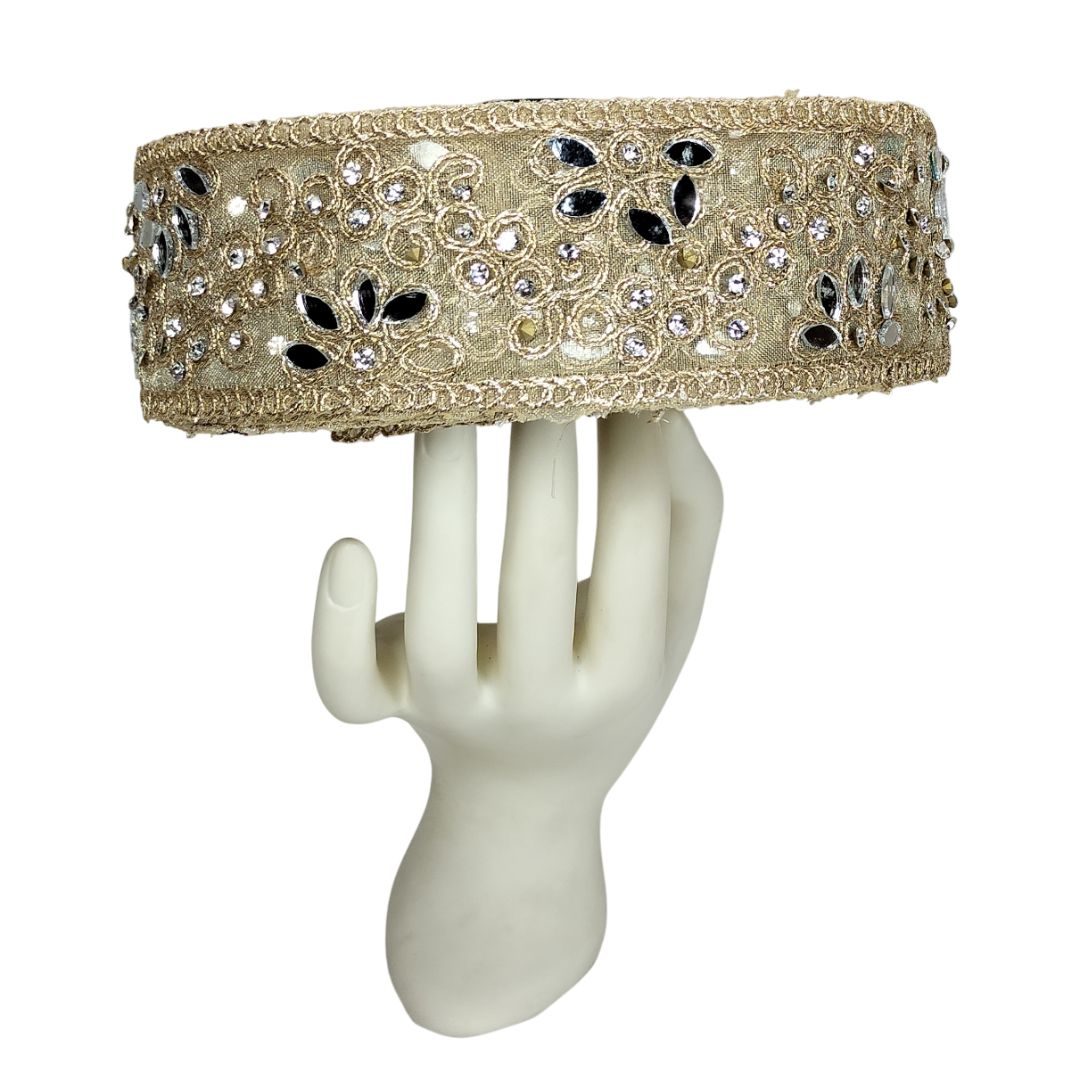Decorative headband with crystals on a white mannequin hand