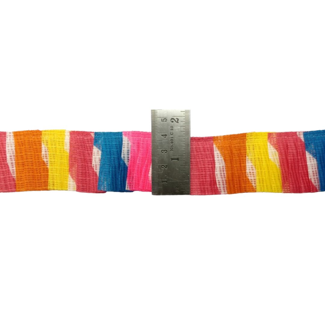 Multicolored striped ribbon with a ruler for scale on a white background