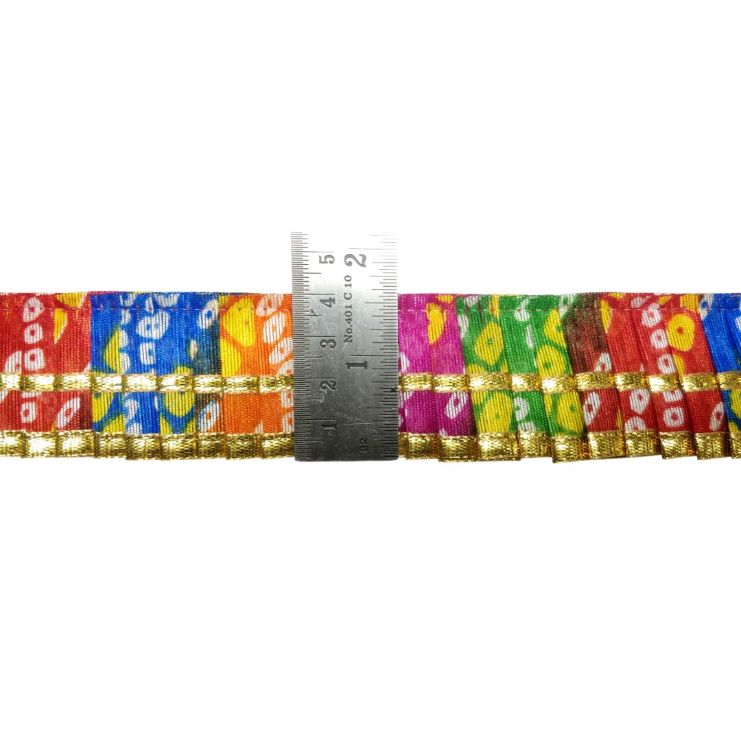 Colorful woven belt with a ruler for scale on a white background