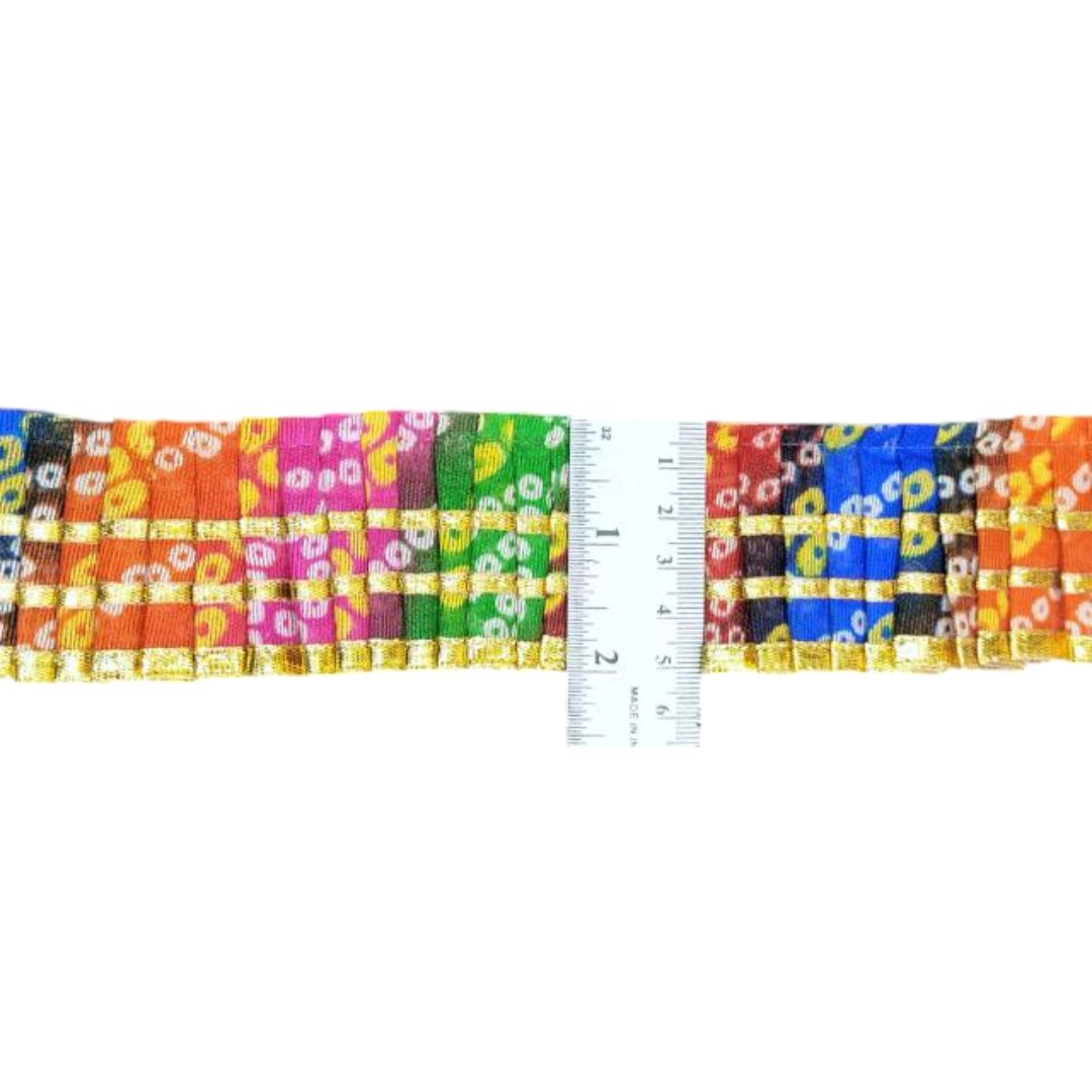 Colorful woven belt with a ruler for scale on a white background