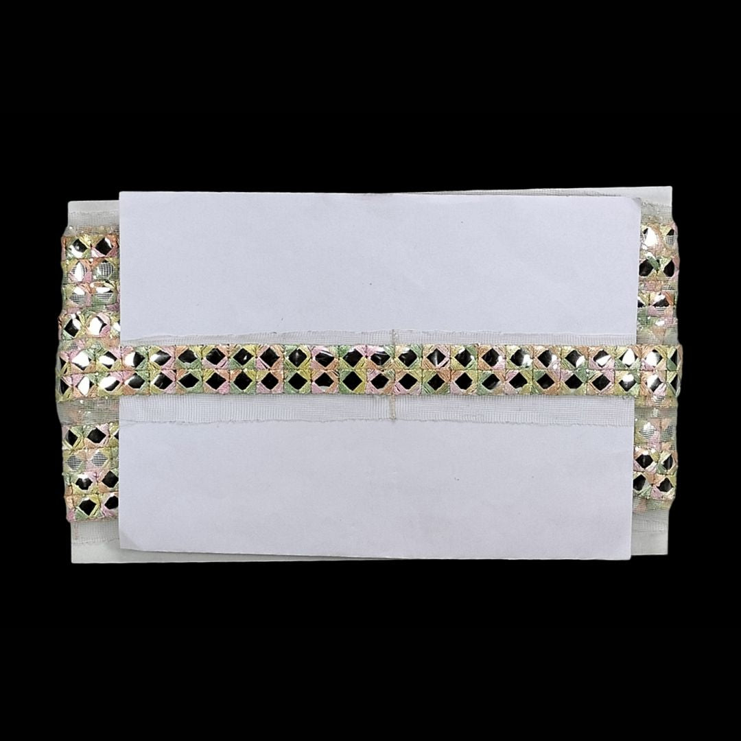 White clutch with decorative embellishments on a white background