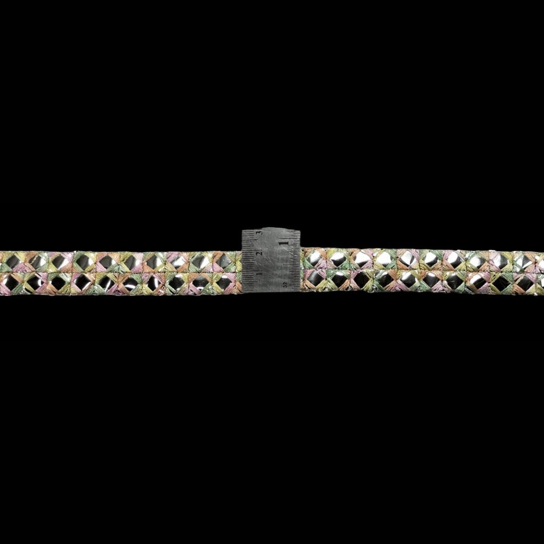 Multicolored rhinestone belt with a ruler for scale on a black background